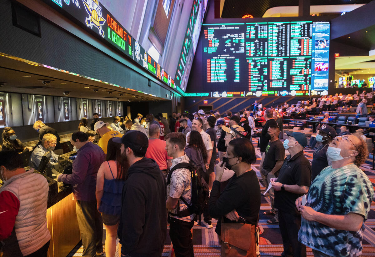 People hurry to place their bets before the start of the NFC Championship NFL football game bet ...