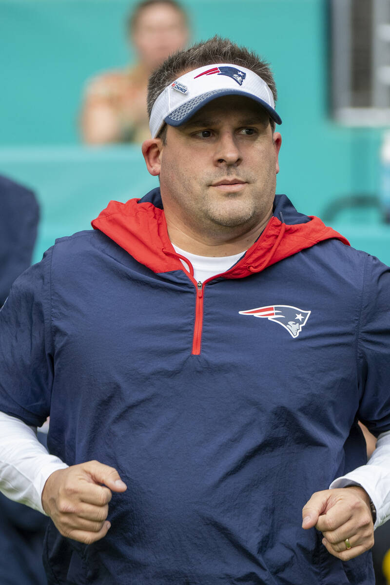 New England Patriots offensive coordinator and quarterbacks coach Josh McDaniels jogs on to the ...