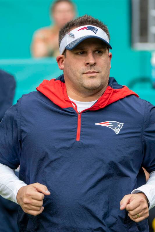 New England Patriots offensive coordinator and quarterbacks coach Josh McDaniels jogs on to the ...