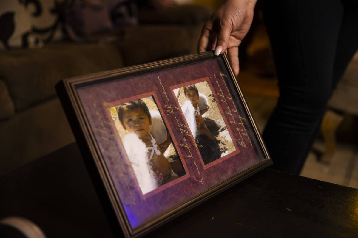 Erlinda Zacarias shows photos of her son Fernando Yeshua Mejia, who was one of 7 family members ...
