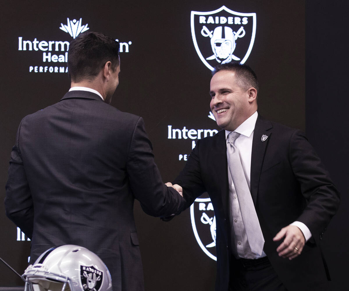 Raiders general manager Dave Ziegler shakes hands with Raiders head coach Josh McDaniels during ...