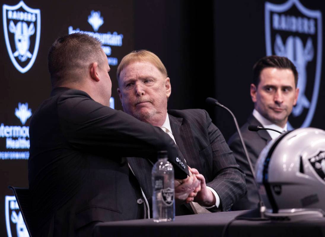 Raiders head coach Josh McDaniels, left, shakes hands with Raiders owner Mark Davis as Raiders ...
