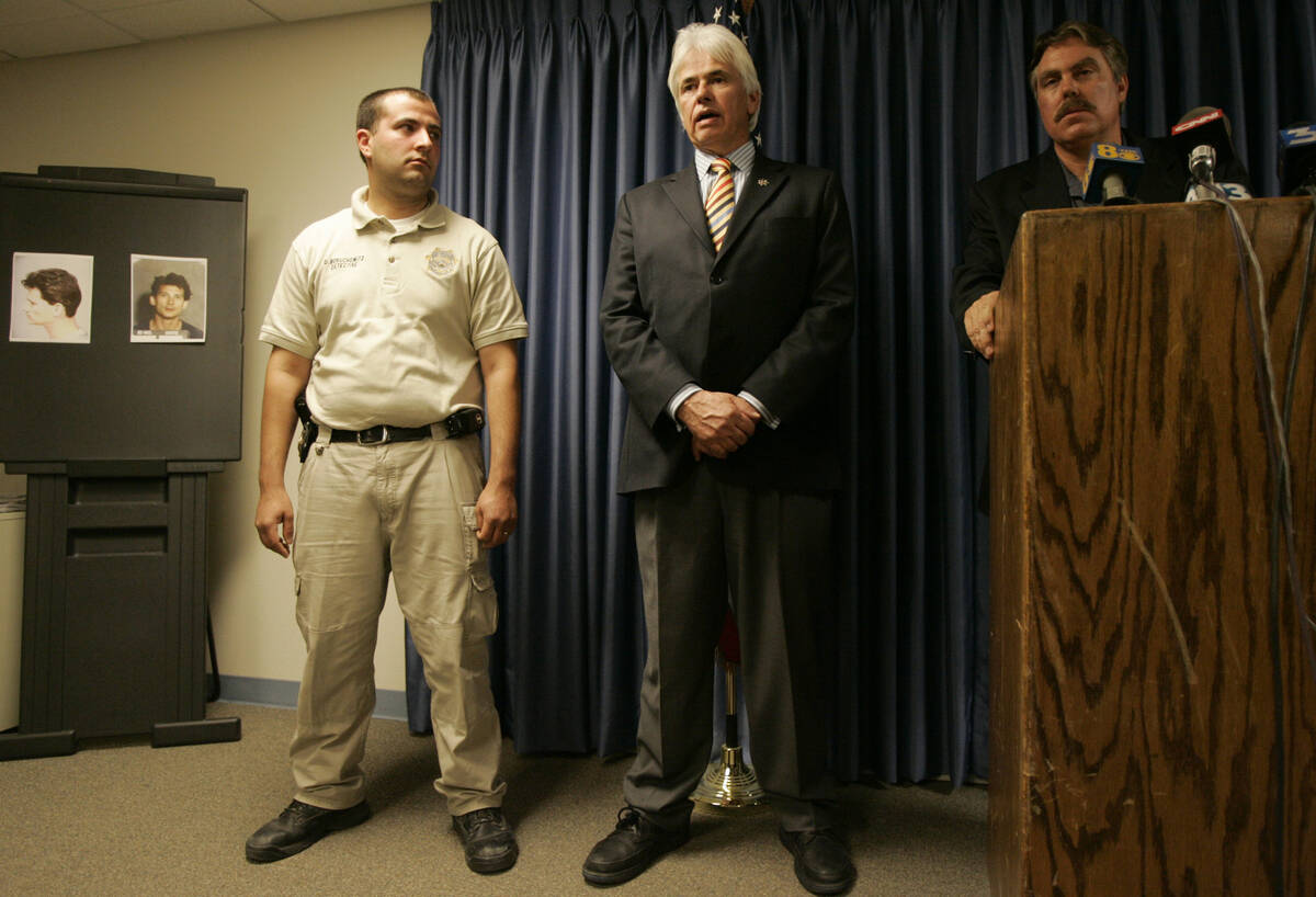 In this Friday, Sept. 28, 2007, file photo, Nye County Sheriff Tony DeMeo, center, speaks as he ...