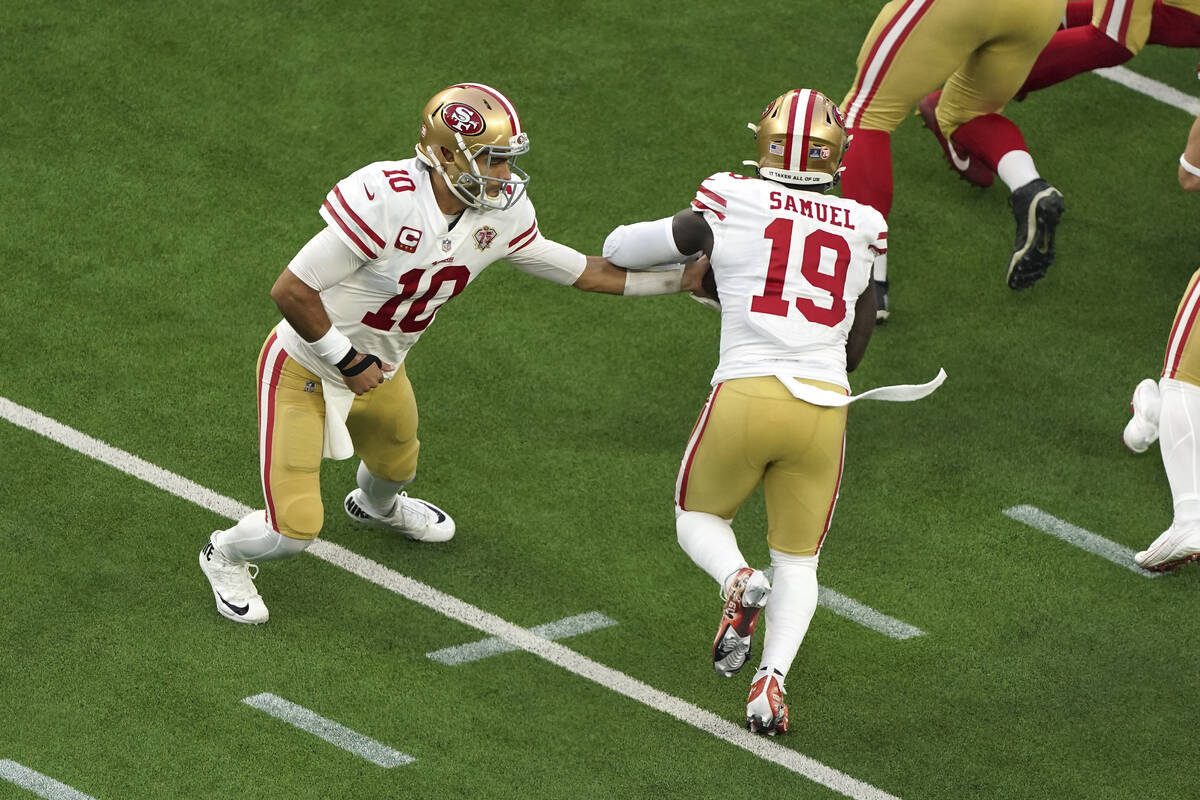 San Francisco 49ers quarterback Jimmy Garoppolo (10) hands the ball off to wide receiver Deebo ...