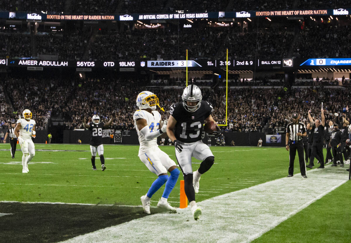 Raiders wide receiver Hunter Renfrow (13) scores a touchdown past Los Angeles Chargers cornerba ...