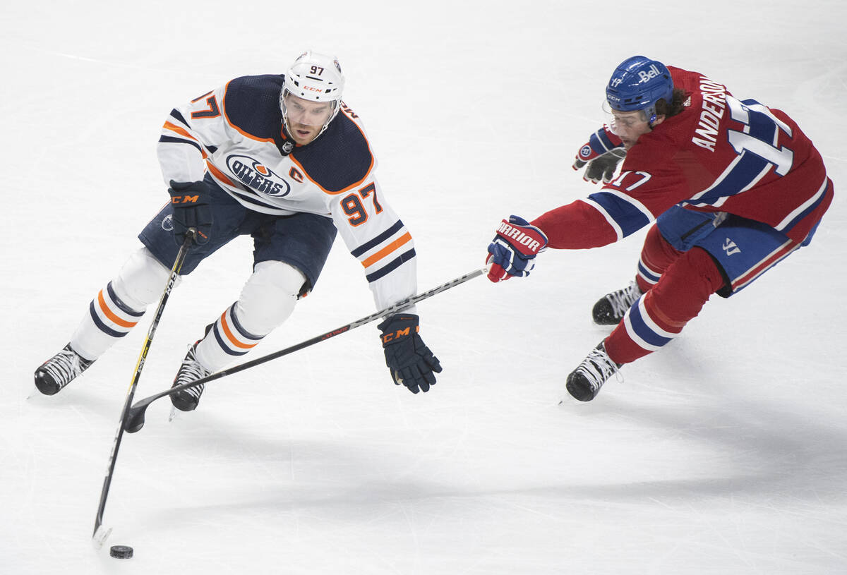 Edmonton Oilers' Connor McDavid (97) gets past Montreal Canadiens' Josh Anderson (17) during fi ...