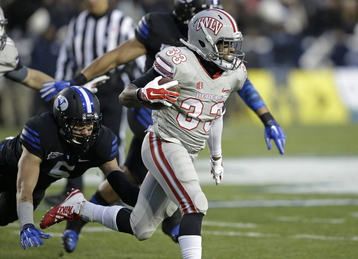 Brigham Young linebacker Alani Fua (5) dives for UNLV running back Shaquille Murray-Lawrence (3 ...