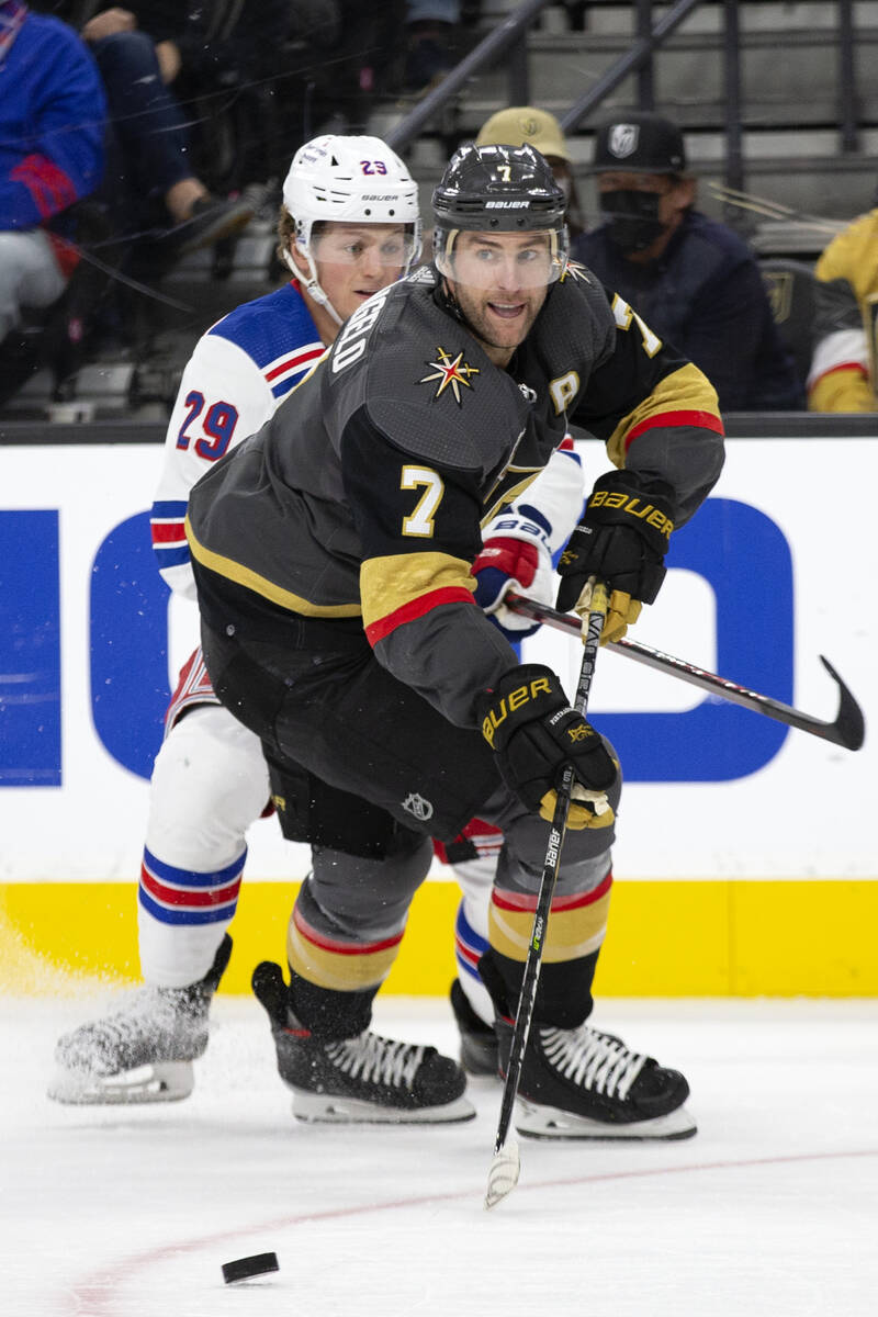 Golden Knights defenseman Alex Pietrangelo (7) passes up the ice while Rangers left wing Dryden ...