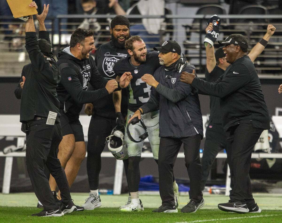 Raiders interim head coach Rich Bisaccia, second from right, is congratulated by assistants and ...