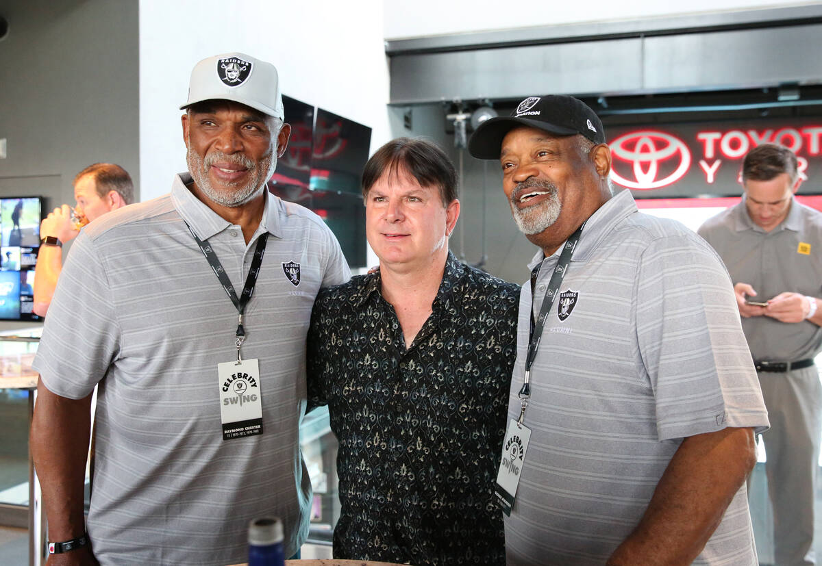 Former Raiders tight end Raymond Chester, left, and safety George Atkinson pose for a photo wit ...