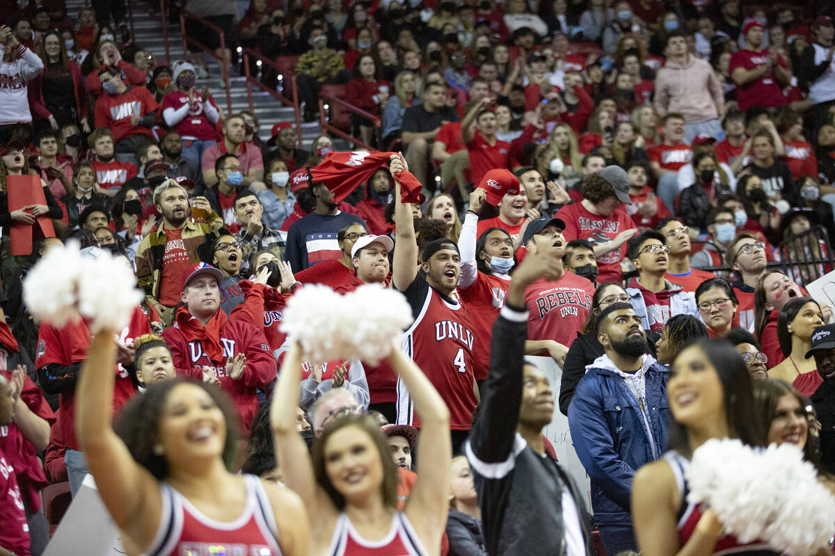 The UNLV Rebels fan section cheers during the first half of an NCAA college basketball game aga ...