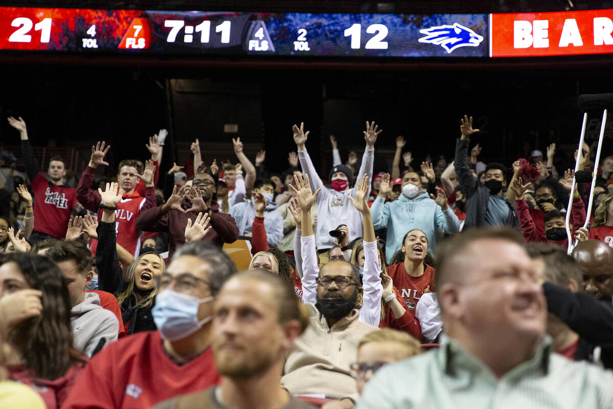 Fans cheer during the first half of an NCAA college basketball game between the UNLV Rebels and ...
