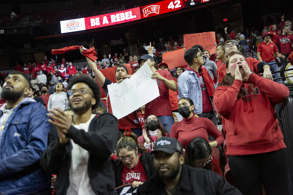 The UNLV Rebels fan section cheers for their team during the second half of an NCAA college bas ...