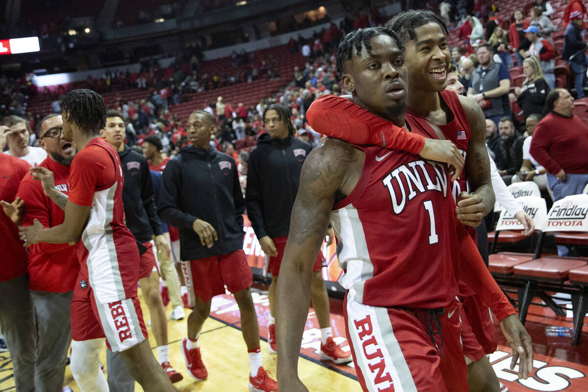 UNLV Rebels guard Michael Nuga (1) and guard Keshon Gilbert (10) embrace as they leave the cour ...