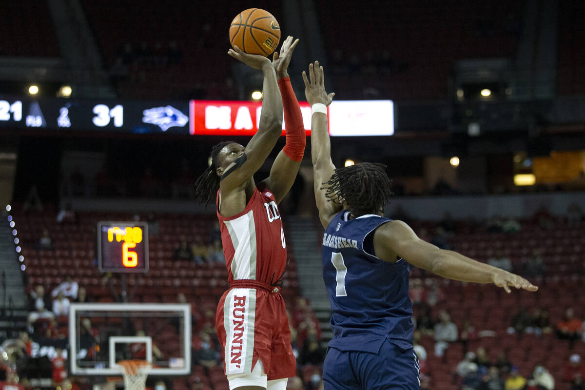 UNLV Rebels forward Victor Iwuakor (0) shoots against Nevada Wolf Pack guard Kenan Blackshear ( ...
