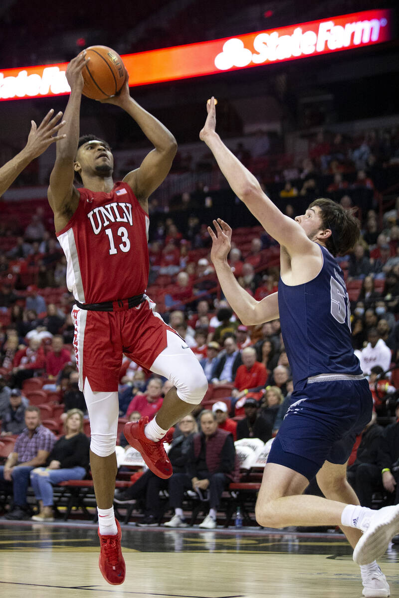 UNLV Rebels guard Bryce Hamilton (13) shoots against Nevada Wolf Pack center Will Baker (50) du ...
