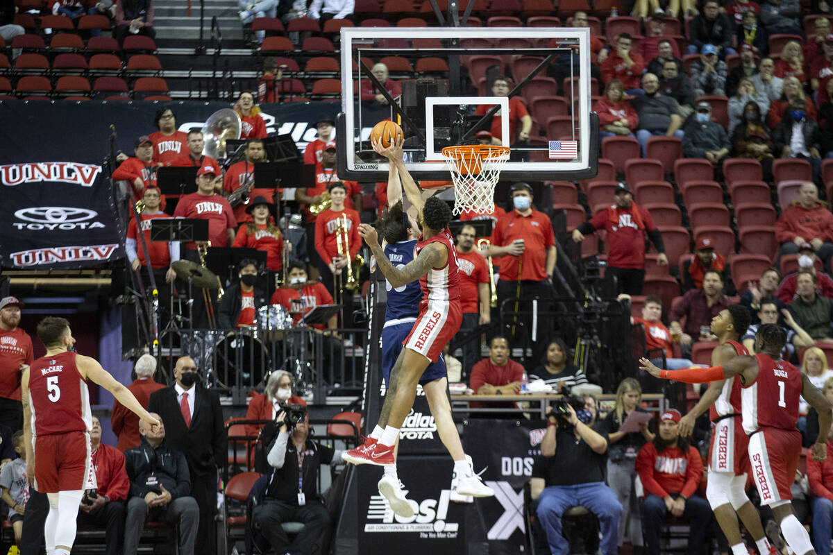 UNLV Rebels forward Royce Hamm Jr. (14) blocks a shot by Nevada Wolf Pack center Will Baker (50 ...