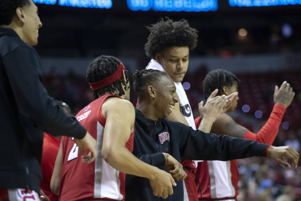 UNLV Rebels players including guard Justin Webster, second from left, guard Josh Baker, center, ...