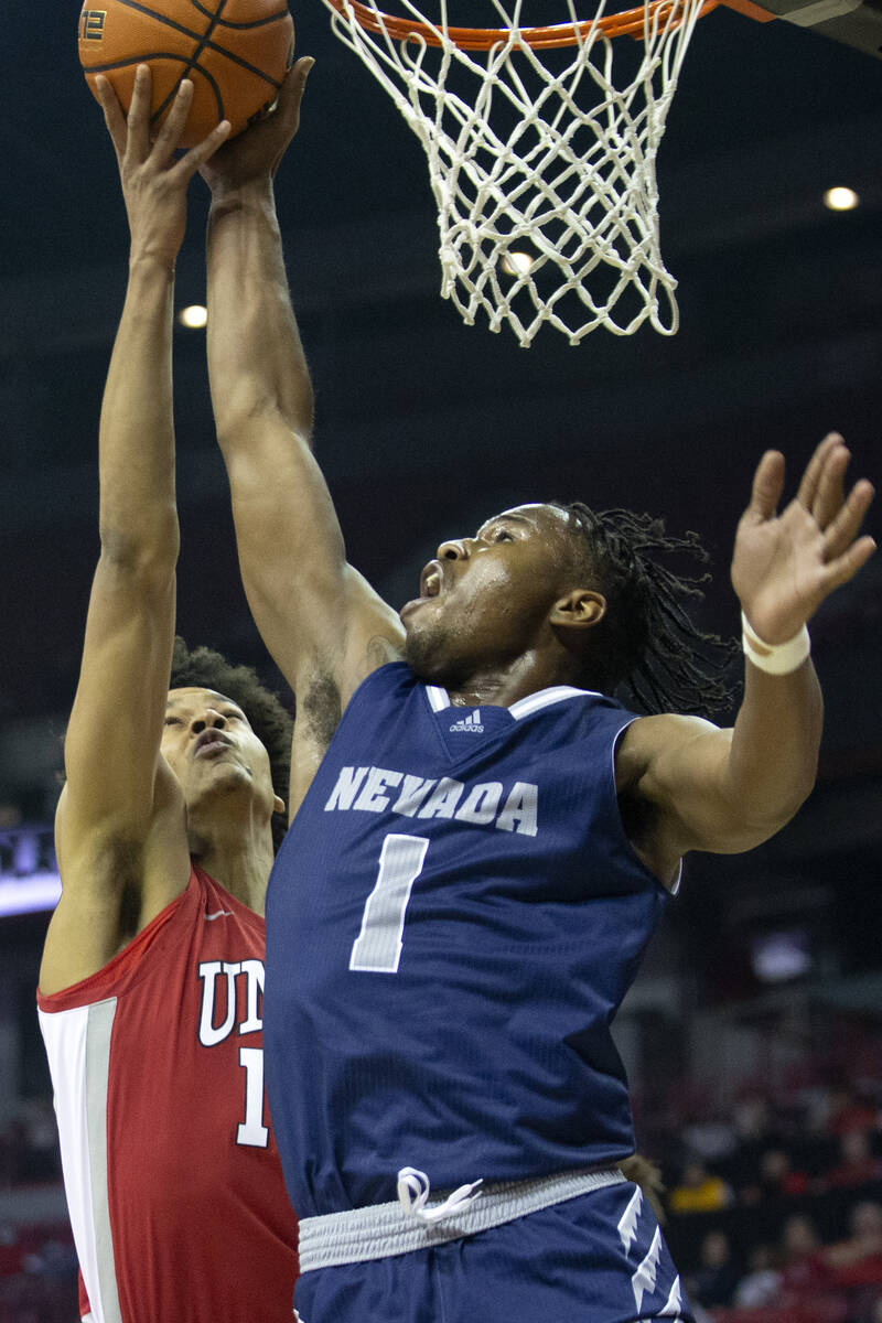 UNLV Rebels center David Muoka (12) blocks a shot by Nevada Wolf Pack guard Kenan Blackshear (1 ...