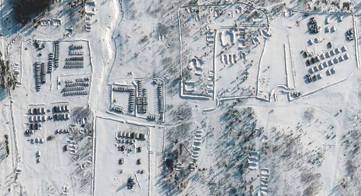 This satellite images provided by Maxar Technologies shows troops gathered at a training ground ...