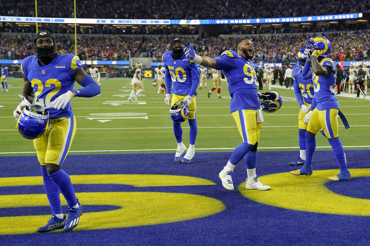 Los Angeles Rams' David Long Jr. (22), Ernest Jones (50) and Aaron Donald celebrate with teamma ...