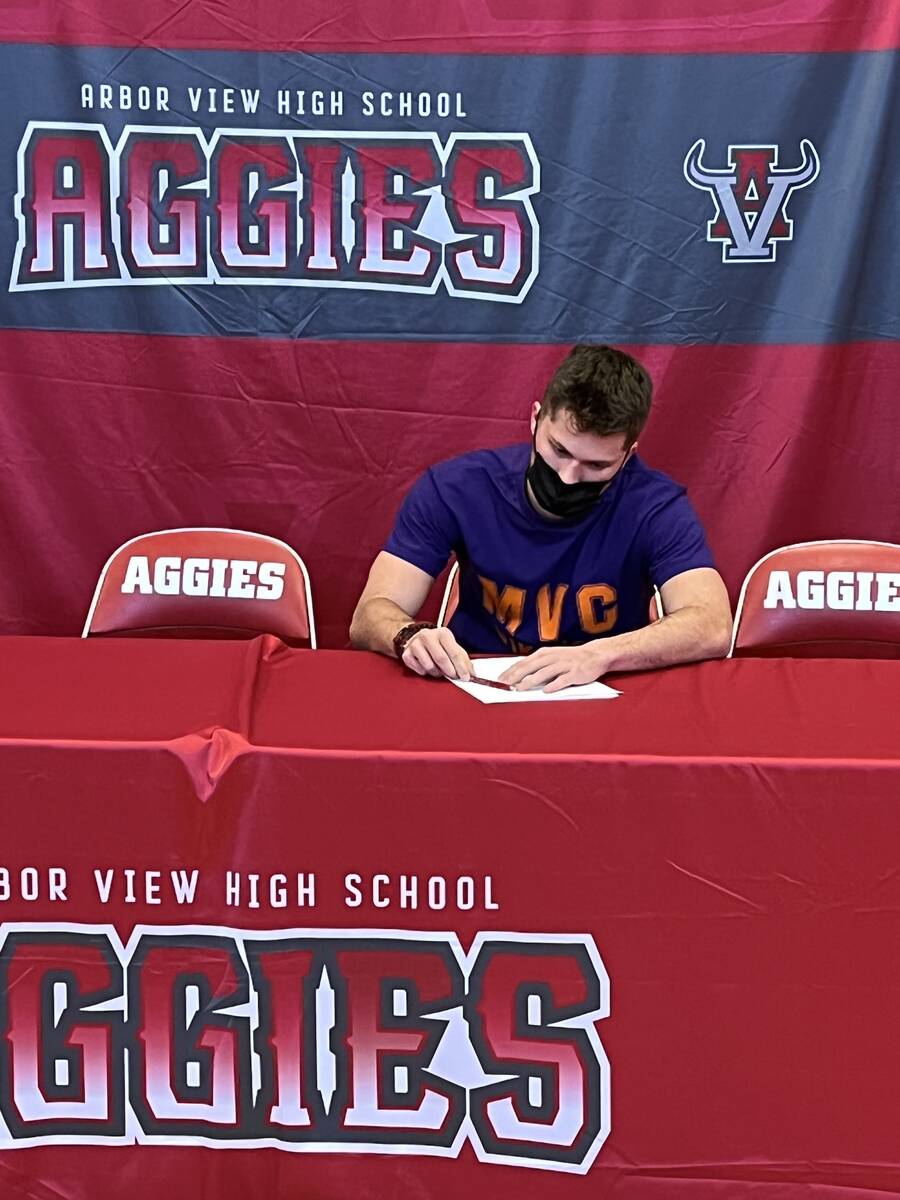 Arbor View quarterback Kyle Holmes signs to play football at Missouri Valley College on Wednesd ...