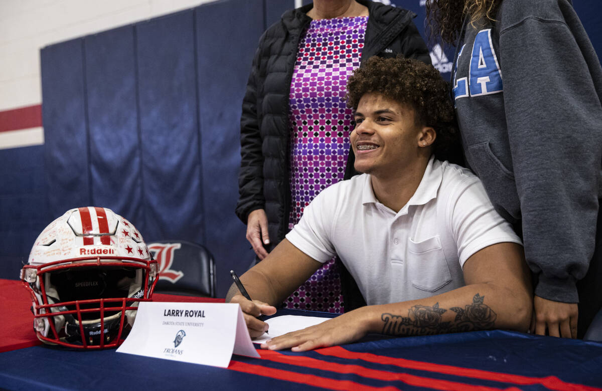 Liberty’s Larry Royal poses for a photo before signing a letter of intent to play footba ...
