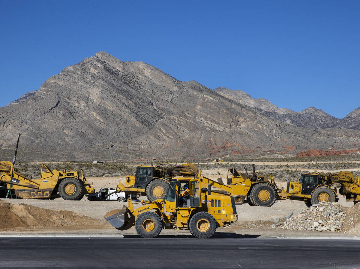 Heavy construction equipments are moving around in the distance as seen from Far Hills Avenue o ...