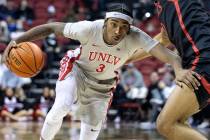 In this Jan. 1, 2022, file photo, UNLV Rebels forward Donovan Williams (3) dribbles around San ...