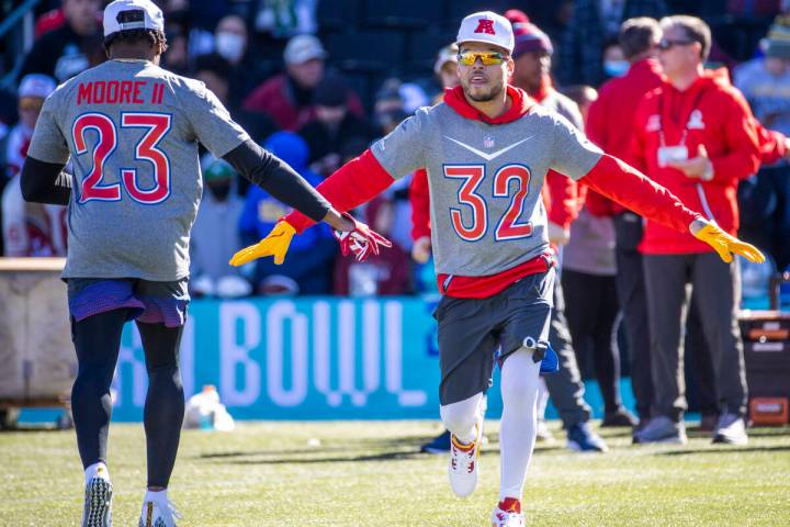 Kansas City Chiefs Tyrann Mathieu (32) greets teammate Indianapolis Colts Kenny Moore II (23) w ...