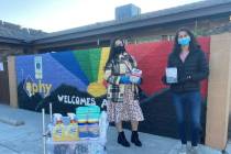 Employees of Rimini Street, a Las Vegas-based software company, pose with donations to the Neva ...