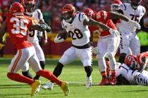 Cincinnati Bengals running back Joe Mixon runs through the Kansas City Chiefs defense during th ...