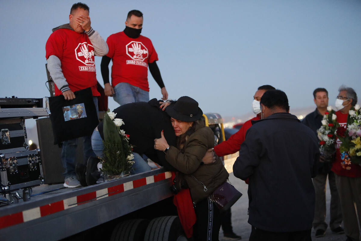 Erlinda Zacarias, center, kneeling down, received a hug during a vigil, Saturday, Feb. 5, 2022, ...