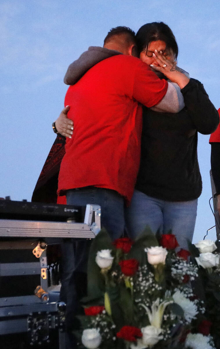 Erlinda Zacarias and her husband Jesus Mejia-Santana show their emotion during a vigil, Saturda ...