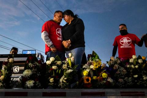 Jesus Mejia-Santana, left and Erlinda Zacarias embrace during a vigil following a vehicle carav ...