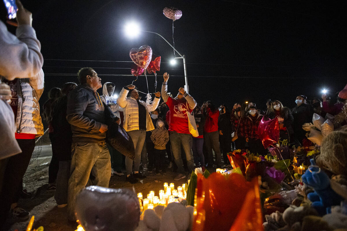 Erlinda Zacarias, center left, and husband Jesus Mejia-Santana, release balloons during a vigil ...