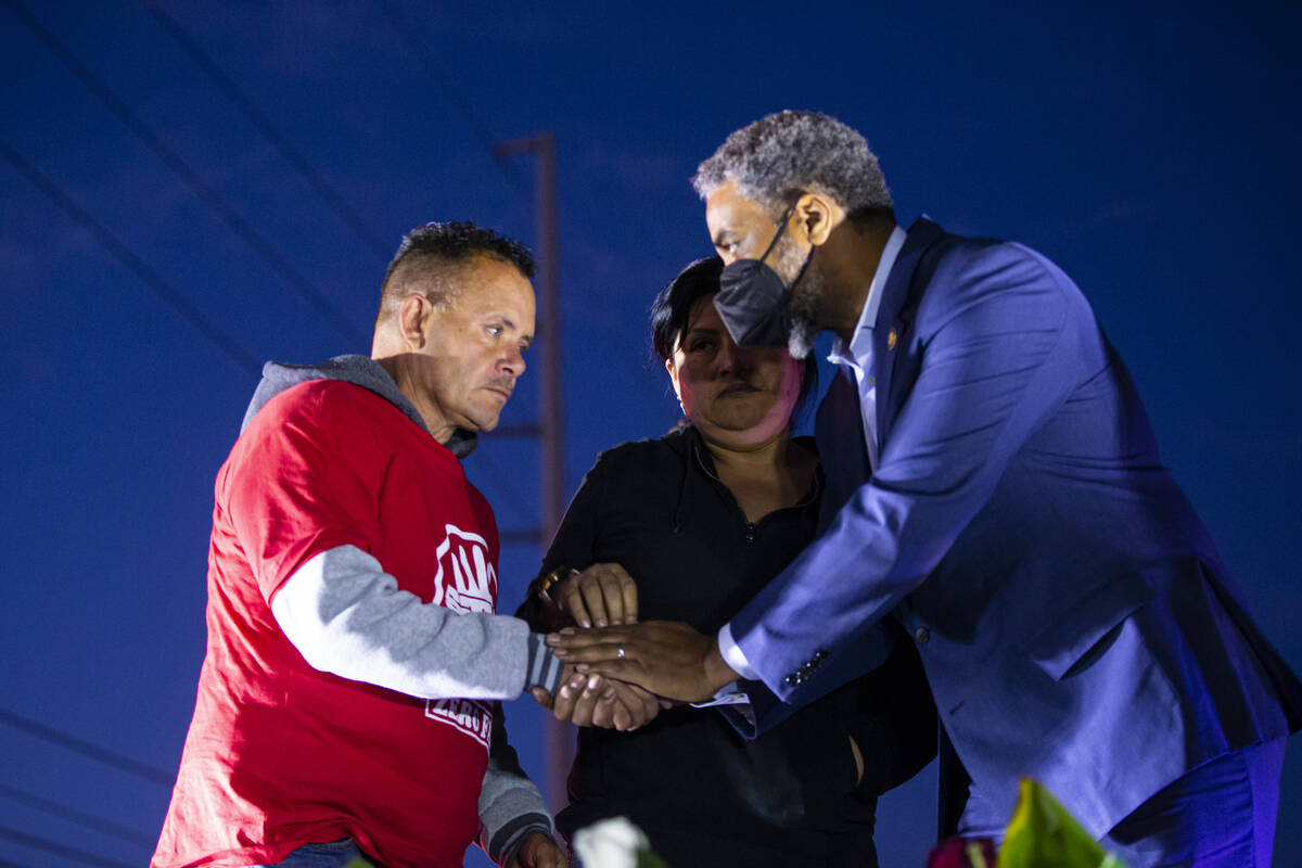 U.S. Rep. Steven Horsford, D-Nev., right, offers condolences to Jesus Mejia-Santana, left and E ...