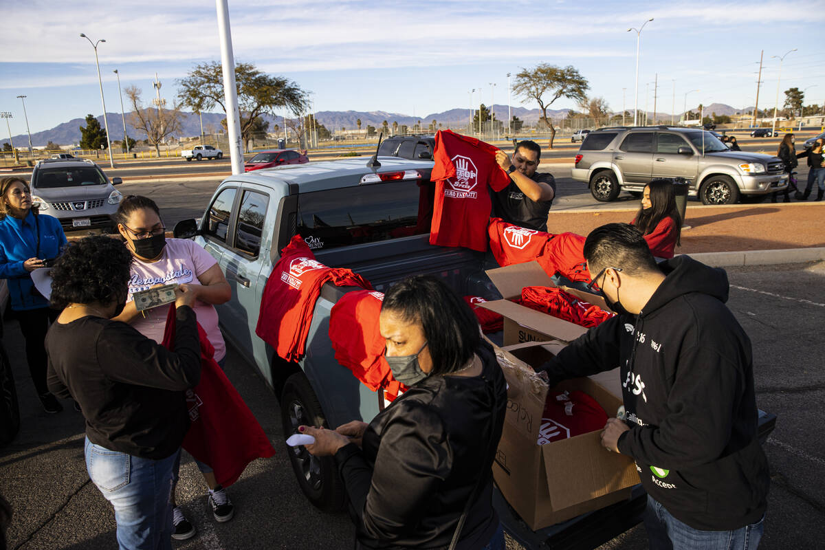 Shirts are sold before the start of a vehicle caravan in memory of the seven Zacarias family me ...