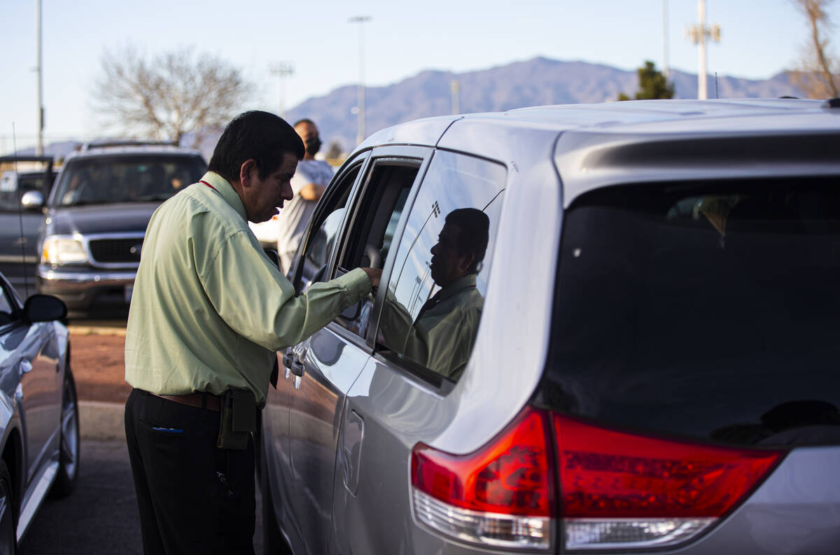North Las Vegas City Councilman Isaac Barron speaks with the Zacarias family before a vehicle c ...