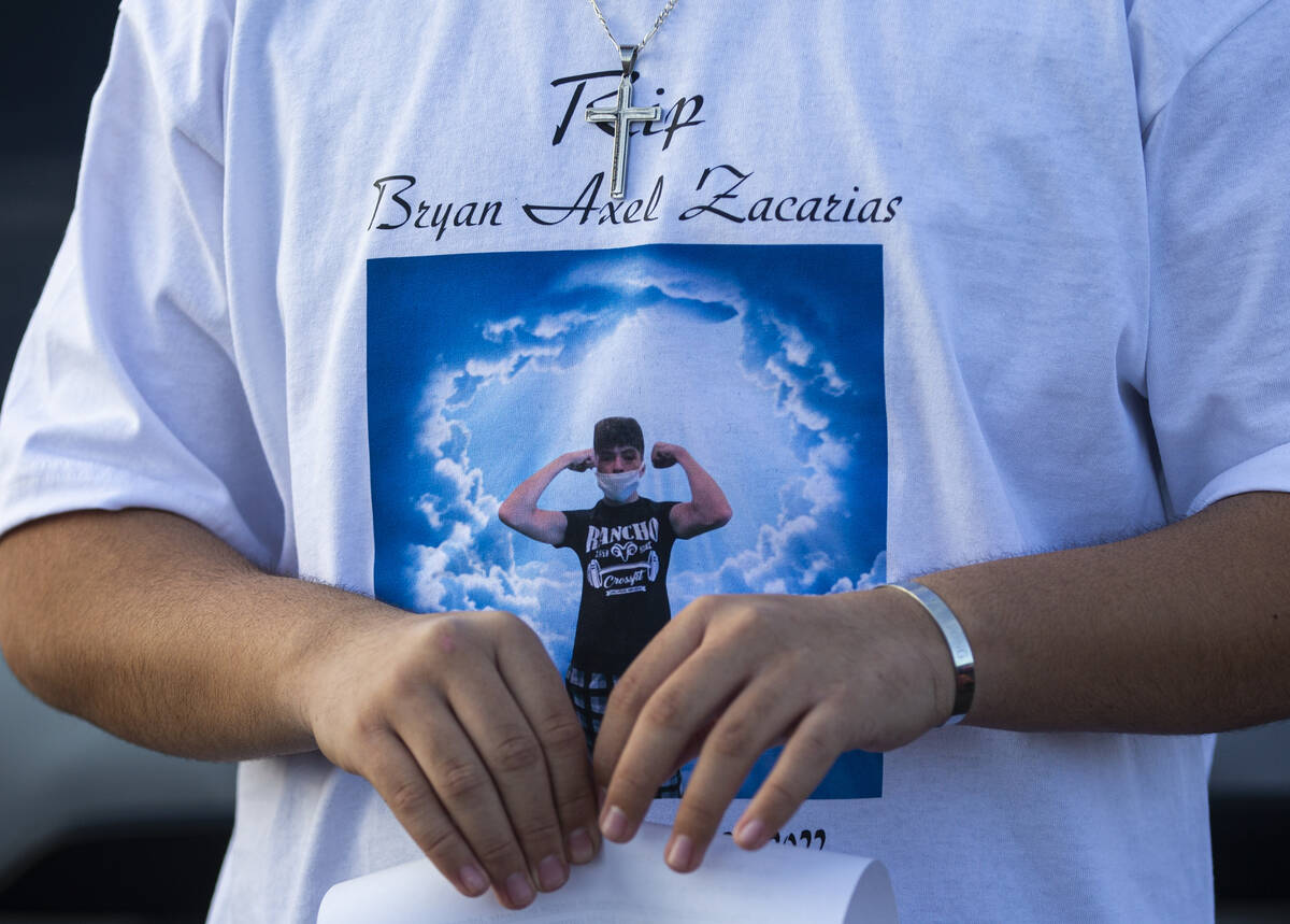 A mourner wears a shirt showing Bryan Zacarias, a Rancho High School student that was one of se ...