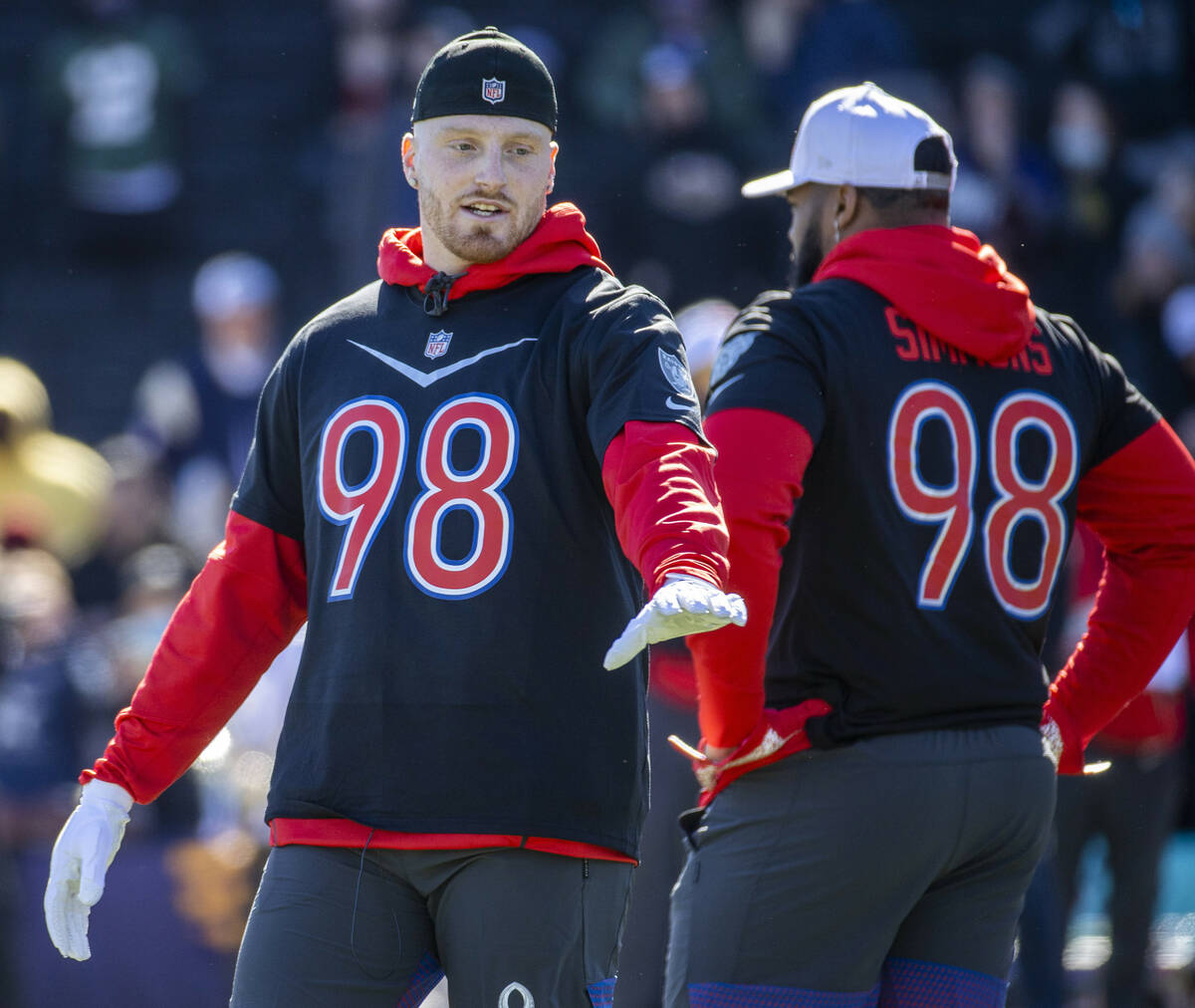 Raiders defensive end Maxx Crosby (98) talks with teammates during AFC Pro Bowl team practice a ...