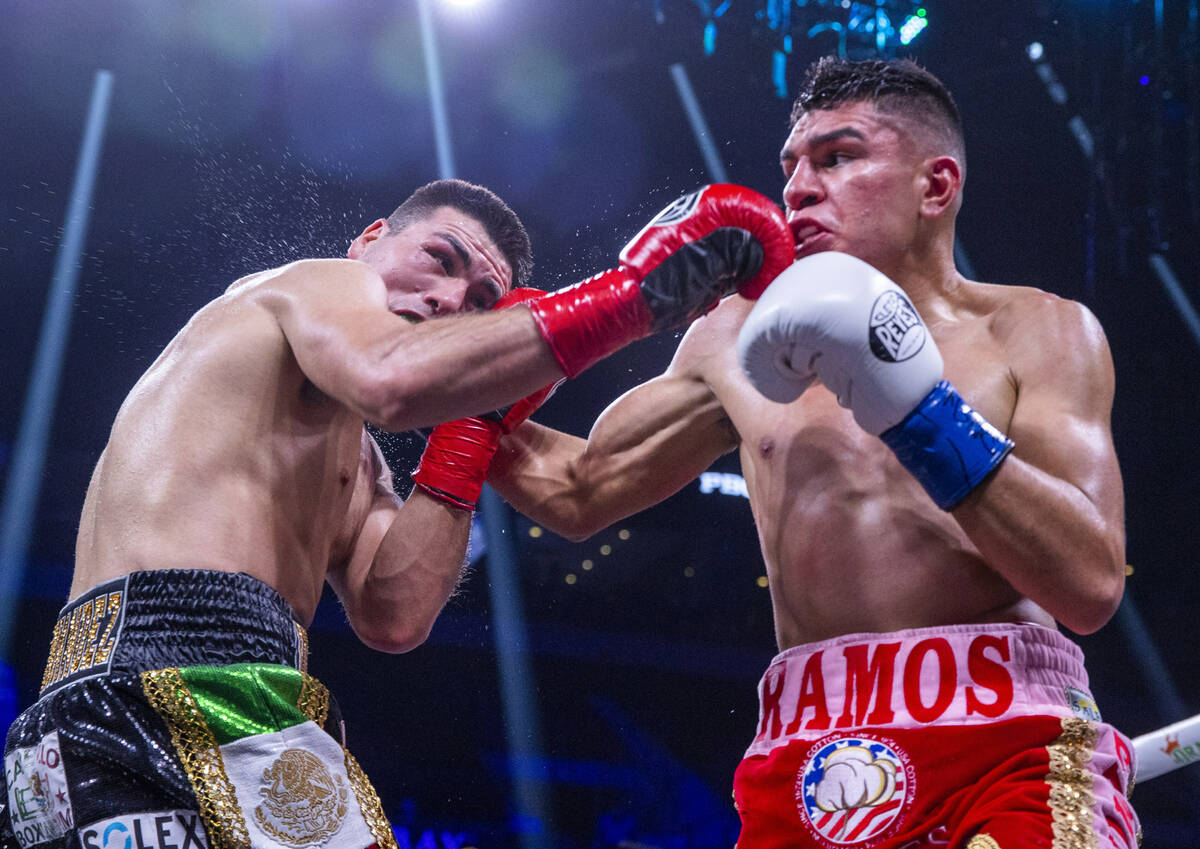 Vladimir Hernandez, left, absorbs a punch from Jesús Ramos and during the third round of t ...