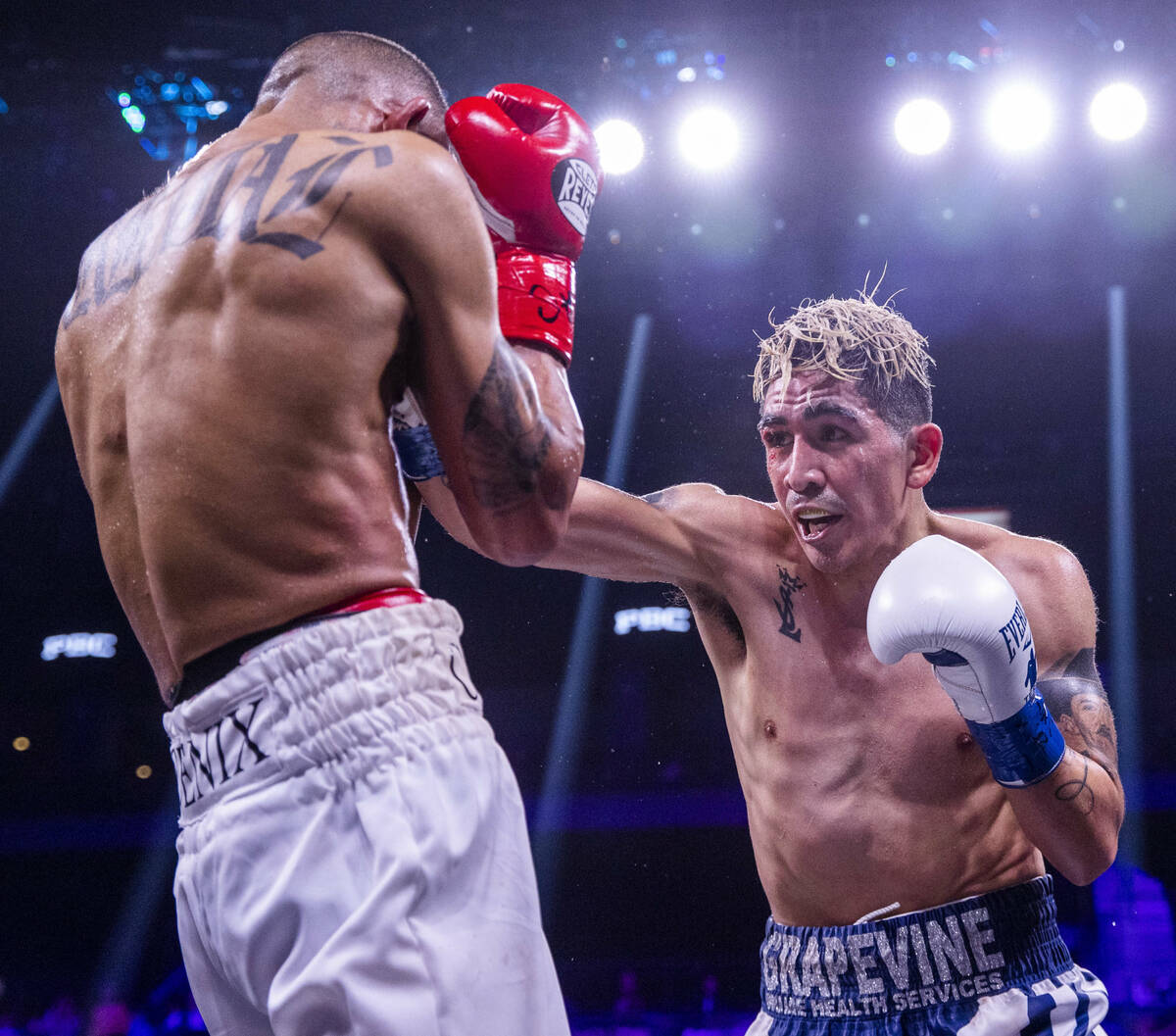Keenan Carbajal, left, is struck by Leo Santa Cruz during the fifth round of their super feathe ...