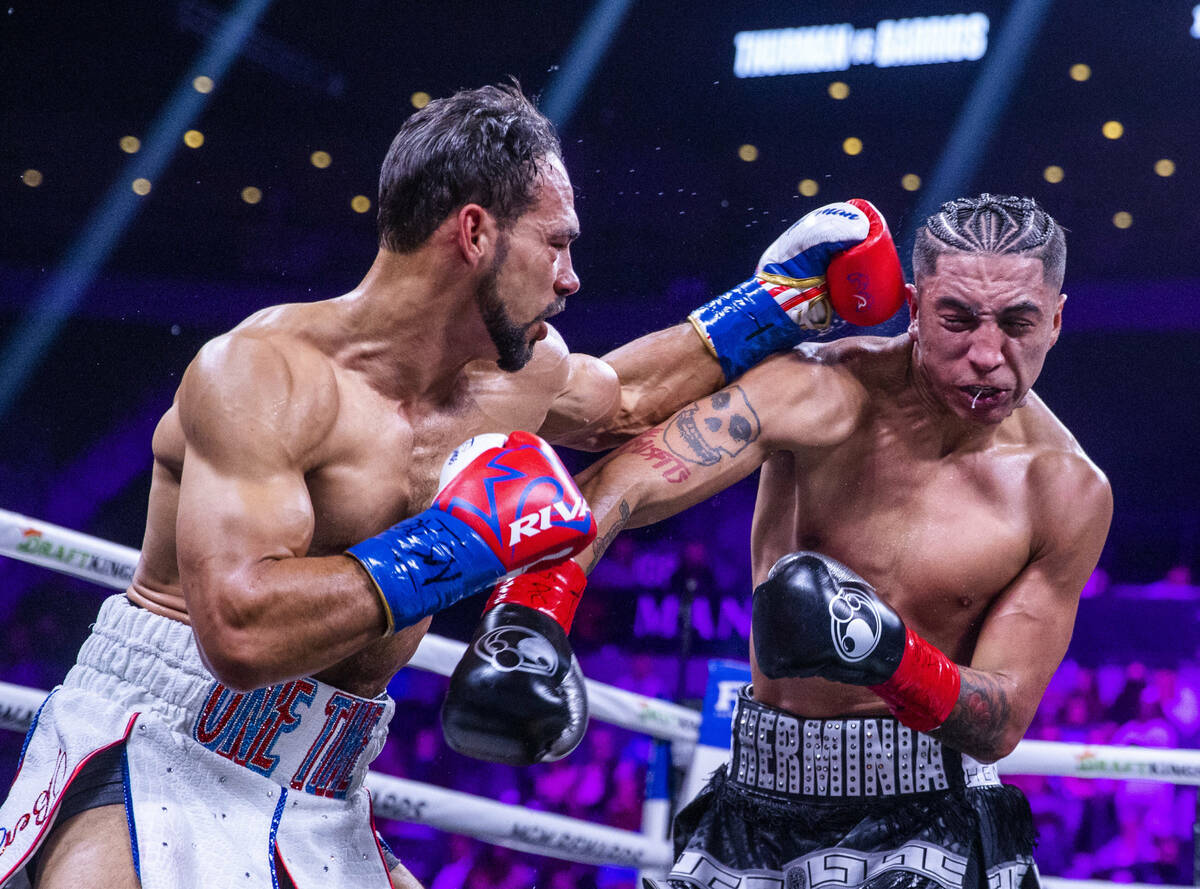 Keith Thurman, left, connects to the head of Mario Barrios during the second round of their Wel ...