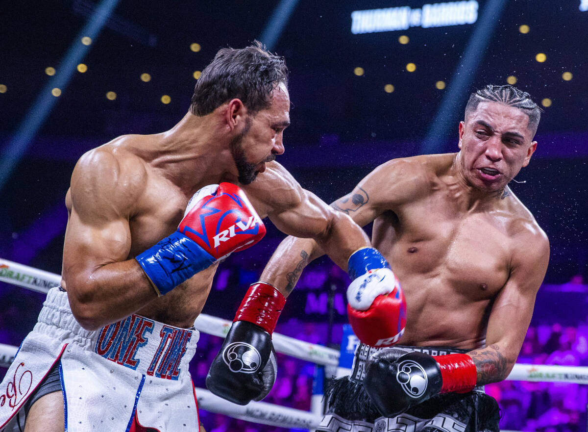 Keith Thurman, left, connects to the head of Mario Barrios during the second round of their Wel ...