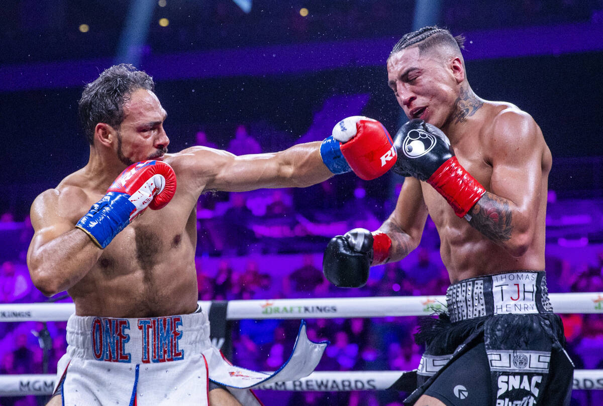 Keith Thurman, left, connects to the chin of Mario Barrios during the fifth round of their Welt ...