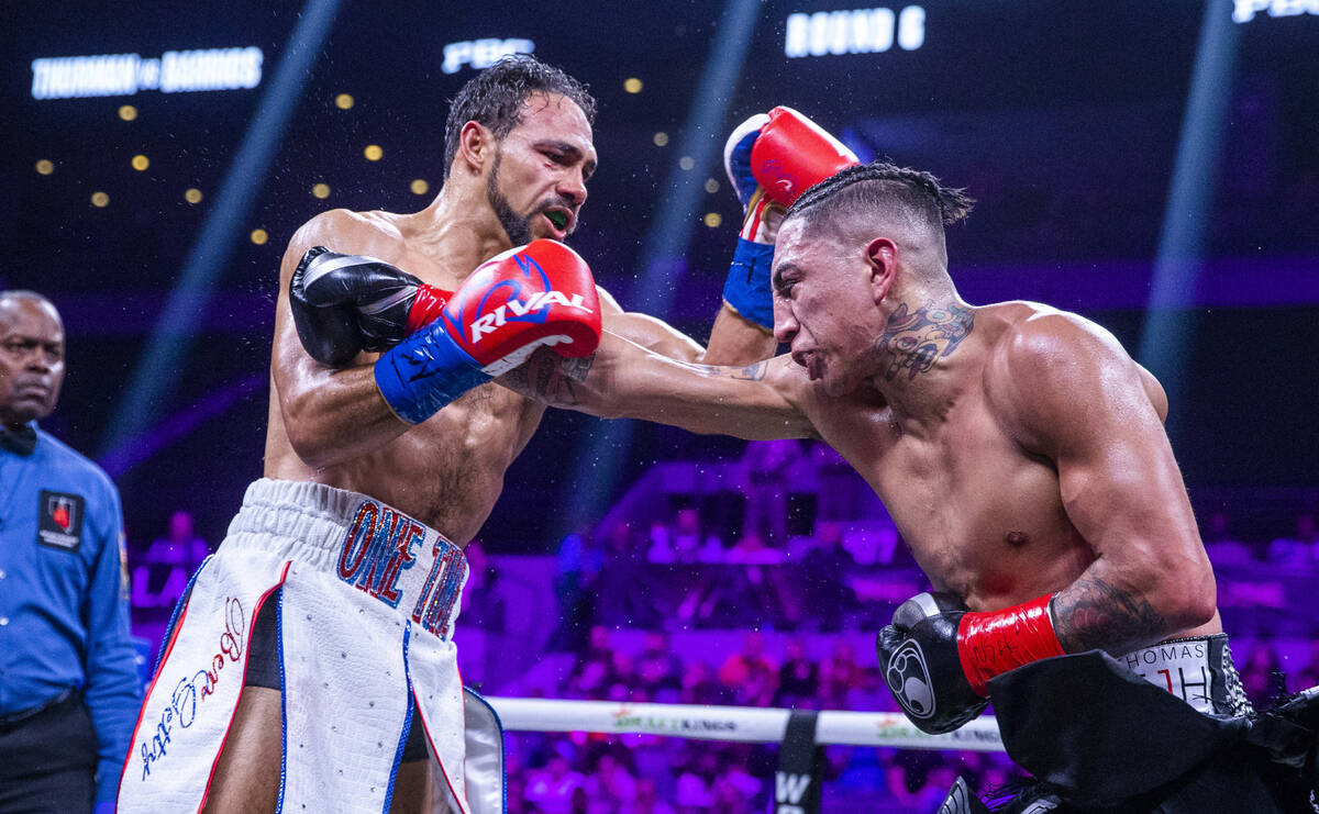 Keith Thurman, left, trades punches with Mario Barrios during the sixth round of their Welterwe ...