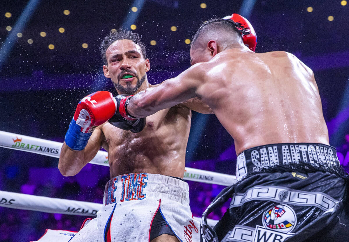 Keith Thurman, left, trades punches with Mario Barrios during the seventh round of their Welter ...