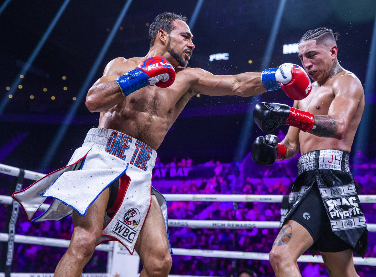 Keith Thurman, left, connects with a punch to the chin of Mario Barrios during the eighth round ...