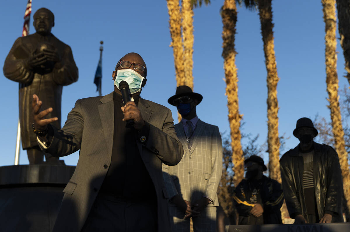 Pastor Kelcey West, left, delivers the opening prayer during an event honoring the victims of t ...